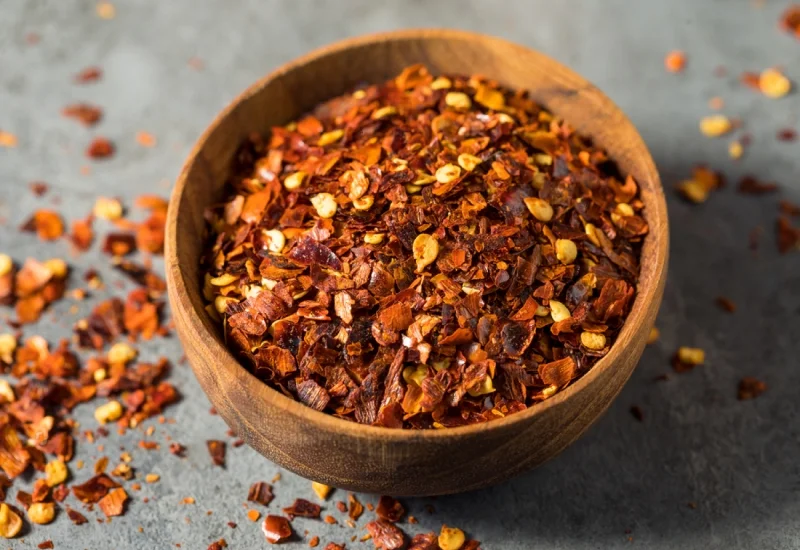 raw organic red pepper flakes in a bowl