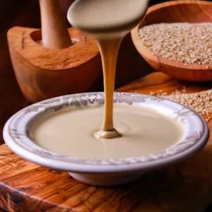 tahini flowing from spoon to plate