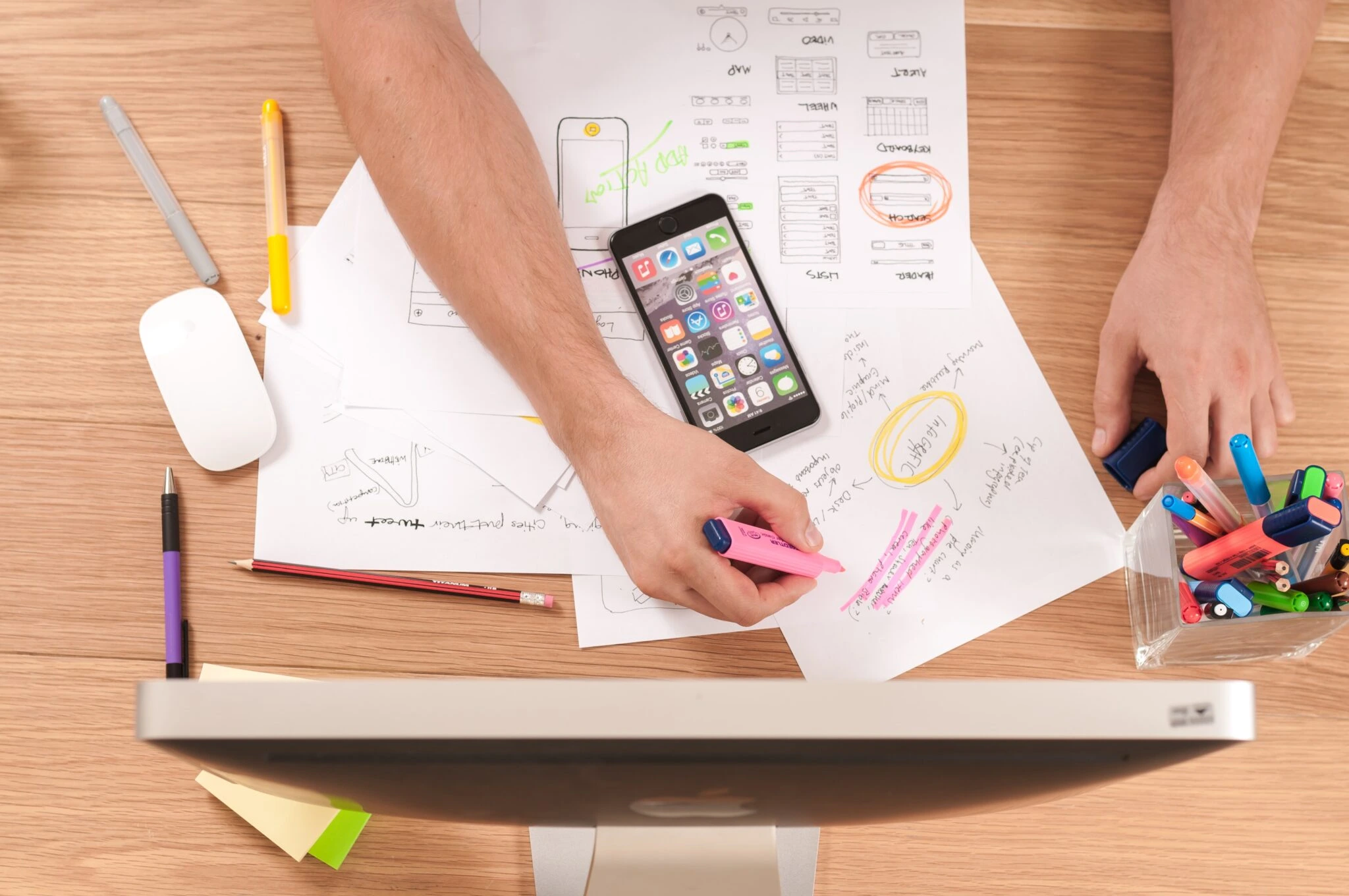 A person studying with pen and paper at his desk to improve his career.